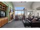 A cozy living room featuring a fireplace, large windows with scenic views, and comfortable seating at 1505 Legacy Trl, Elizabeth, CO 80107