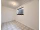 Finished basement room offers natural light with an egress window and durable tile flooring at 1720 S Ammons St # A, Lakewood, CO 80232