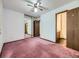 Bedroom with carpet, closet with mirrored doors, and connected bathroom at 1720 S Ammons St # A, Lakewood, CO 80232