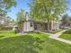Charming brick home featuring a well-manicured lawn and mature tree at 1720 S Ammons St # A, Lakewood, CO 80232