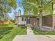 Charming brick home featuring a well-manicured lawn and mature tree at 1720 S Ammons St # A, Lakewood, CO 80232