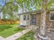 Charming brick home featuring a well-manicured lawn and mature tree at 1720 S Ammons St # A, Lakewood, CO 80232
