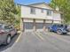 Modern townhome exterior features three garages and ample parking space in front at 1720 S Ammons St # A, Lakewood, CO 80232