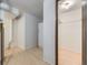 Hallway with closet and full size fridge provides storage space in finished basement at 1720 S Ammons St # A, Lakewood, CO 80232