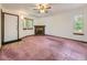 Spacious living room with fireplace, carpet flooring, and natural light at 1720 S Ammons St # A, Lakewood, CO 80232