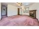 Spacious living room with fireplace, carpet flooring, and natural light at 1720 S Ammons St # A, Lakewood, CO 80232