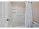 Bathroom with a white shower and tub combination with shelving and a white shower curtain at 1731 S Blackhawk Way # A, Aurora, CO 80012