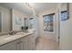 Bright bathroom features a single sink vanity with a large mirror and natural light from the window at 1731 S Blackhawk Way # A, Aurora, CO 80012