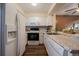 Functional kitchen featuring white appliances and granite countertops at 1731 S Blackhawk Way # A, Aurora, CO 80012