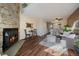 Cozy living room features a stone fireplace and seamlessly connects to the adjacent kitchen area at 1731 S Blackhawk Way # A, Aurora, CO 80012