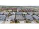 An aerial view showcases a neighborhood with well-maintained homes and green spaces in a suburban setting at 15402 E 113Th Pl, Commerce City, CO 80022