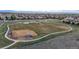 Aerial view of community park including baseball field, playground, and walking path at 15402 E 113Th Pl, Commerce City, CO 80022