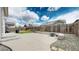 Back patio with a built-in seating area, fire pit, and fenced yard, perfect for gatherings at 15402 E 113Th Pl, Commerce City, CO 80022