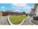 Fenced backyard featuring a green lawn and landscaped areas for outdoor living and entertaining at 15402 E 113Th Pl, Commerce City, CO 80022