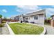 Backyard featuring a well-maintained lawn, patio area, and plenty of space for outdoor activities at 15402 E 113Th Pl, Commerce City, CO 80022