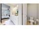 Bathroom with double vanity leading into the bedroom at 15402 E 113Th Pl, Commerce City, CO 80022