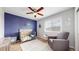 Cozy Bedroom with a crib, chair, and celestial-themed decor at 15402 E 113Th Pl, Commerce City, CO 80022