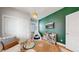 Cozy bedroom with a green accent wall, toy shelf, and a teepee tent at 15402 E 113Th Pl, Commerce City, CO 80022