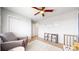 Bright Bedroom with a comfy chair, storage, and a crib at 15402 E 113Th Pl, Commerce City, CO 80022