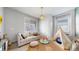 Bright bedroom with a couch, textured rug, pendant light, and a teepee tent at 15402 E 113Th Pl, Commerce City, CO 80022