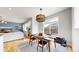 Bright dining area with modern lighting and an open layout, perfect for entertaining at 15402 E 113Th Pl, Commerce City, CO 80022