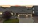 Charming home exterior featuring a two-car garage and well-maintained landscaping at 15402 E 113Th Pl, Commerce City, CO 80022