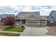 Charming single-Gathering home featuring a three-car garage and a well-manicured lawn at 15402 E 113Th Pl, Commerce City, CO 80022
