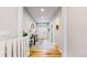 Inviting foyer with hardwood floors, a console table, and a view of the front door at 15402 E 113Th Pl, Commerce City, CO 80022