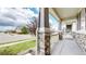 Inviting covered front porch with stone supports and views of the landscaped front yard at 15402 E 113Th Pl, Commerce City, CO 80022