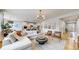 Open concept living room with hardwood floors, modern lighting, and ample seating at 15402 E 113Th Pl, Commerce City, CO 80022