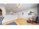 Bright loft featuring hardwood floors, art, and comfortable seating at 15402 E 113Th Pl, Commerce City, CO 80022