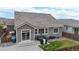 Rear exterior view showcasing a patio, manicured lawn, and outdoor living space in a private backyard at 15402 E 113Th Pl, Commerce City, CO 80022