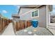 Side yard featuring a fence, gravel, and a convenient trash bin storage area at 15402 E 113Th Pl, Commerce City, CO 80022