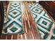 Wood flooring with patterned rugs create stylish transition between spaces and provide a visually appealing hallway at 9115 W 2Nd Ave, Lakewood, CO 80226