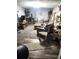 Comfortable living room featuring carpet and wood flooring, a neutral color scheme, and rustic furniture pieces at 9115 W 2Nd Ave, Lakewood, CO 80226