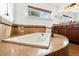 Relaxing bathroom with a corner soaking tub and tiled surround at 936 Eudora St # 102, Denver, CO 80220