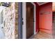 Interior entryway with stone wall and dark brown door at 936 Eudora St # 102, Denver, CO 80220