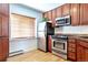 Kitchen features stainless steel appliances and wood cabinets at 936 Eudora St # 102, Denver, CO 80220