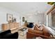 Open living and dining area with light brown couches and mid-century modern decor at 936 Eudora St # 102, Denver, CO 80220