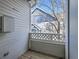 Cozy balcony with wooden floors and white railings, offering a glimpse of the neighborhood at 12941 Lafayette St # E, Thornton, CO 80241