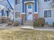 Detailed view of a townhome entrance with blue and brick accents at 12941 Lafayette St # E, Thornton, CO 80241