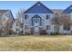 Charming townhome featuring a blue and gray exterior and a well-maintained front yard at 12941 Lafayette St # E, Thornton, CO 80241