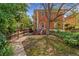 Spacious backyard featuring three chairs and a partial view of the brick exterior of the home at 187 S Pearl St, Denver, CO 80209