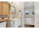 Bright bathroom with modern fixtures, floral wallpaper, and a charming, updated vanity at 187 S Pearl St, Denver, CO 80209