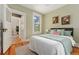 Light-filled bedroom with stylish decor, hardwood floors, and doorway leading to another room with built in storage at 187 S Pearl St, Denver, CO 80209