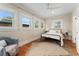 Comfortable bedroom with abundant natural light, a ceiling fan, and a cozy sitting area at 187 S Pearl St, Denver, CO 80209