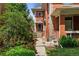 Brick home exterior and entryway framed by lush landscaping at 187 S Pearl St, Denver, CO 80209