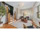 Cozy living room featuring hardwood floors, a stylish rug, and natural light from the windows at 187 S Pearl St, Denver, CO 80209