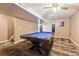 Finished basement with a pool table and neutral walls at 1115 Cherry Ct, Fort Lupton, CO 80621