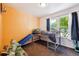 Bright bedroom with orange accent wall, platform bed, and lots of natural light at 1115 Cherry Ct, Fort Lupton, CO 80621